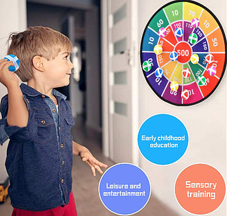 A boy is playing a dart board game with a ball.